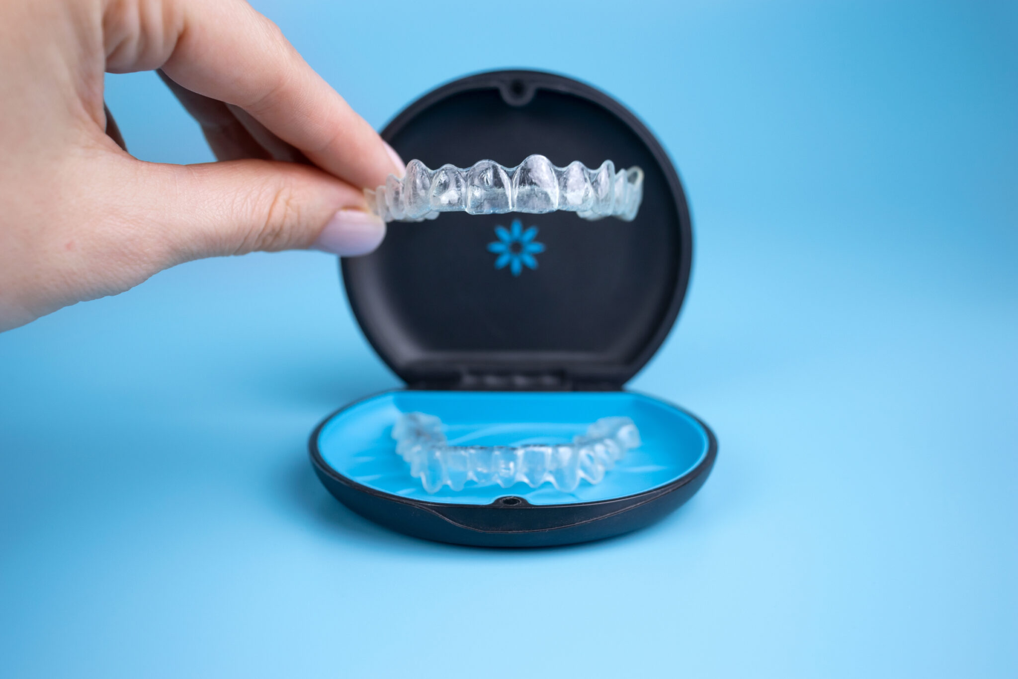 Clear aligner held above an aligner case