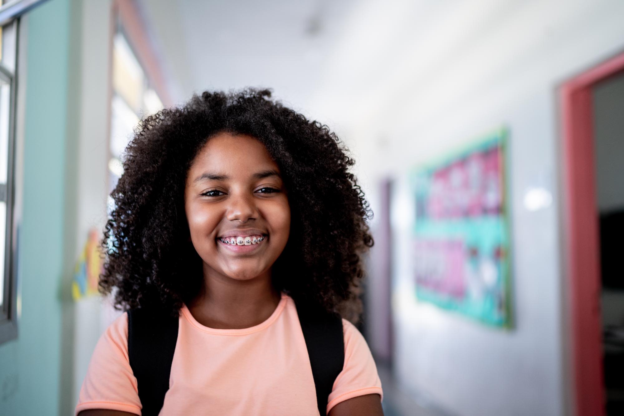 Child smiling with braces during phase 1 orthodontic treatment