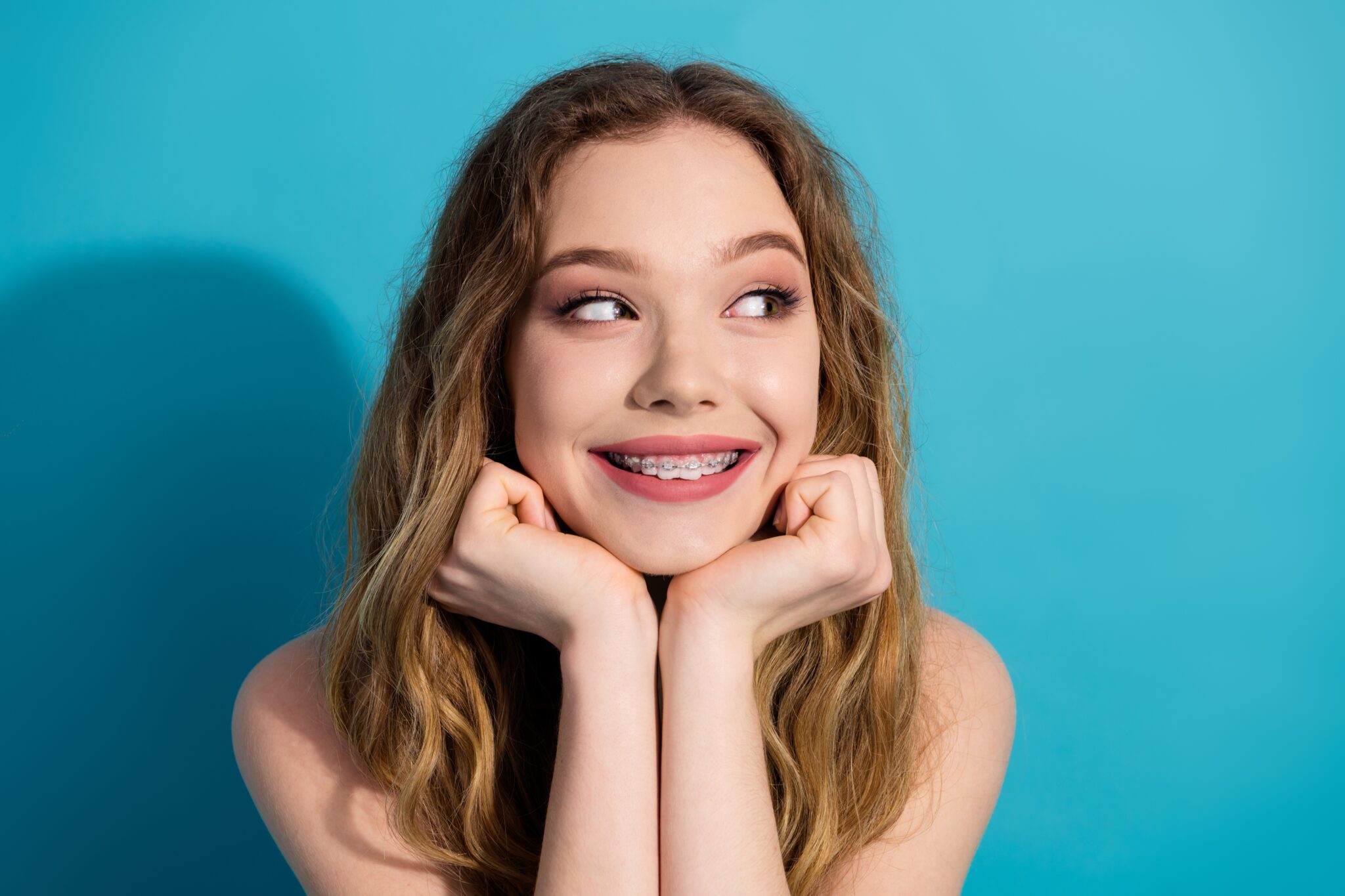 Teen patient smiling after starting braces treatment on the same day as consultation