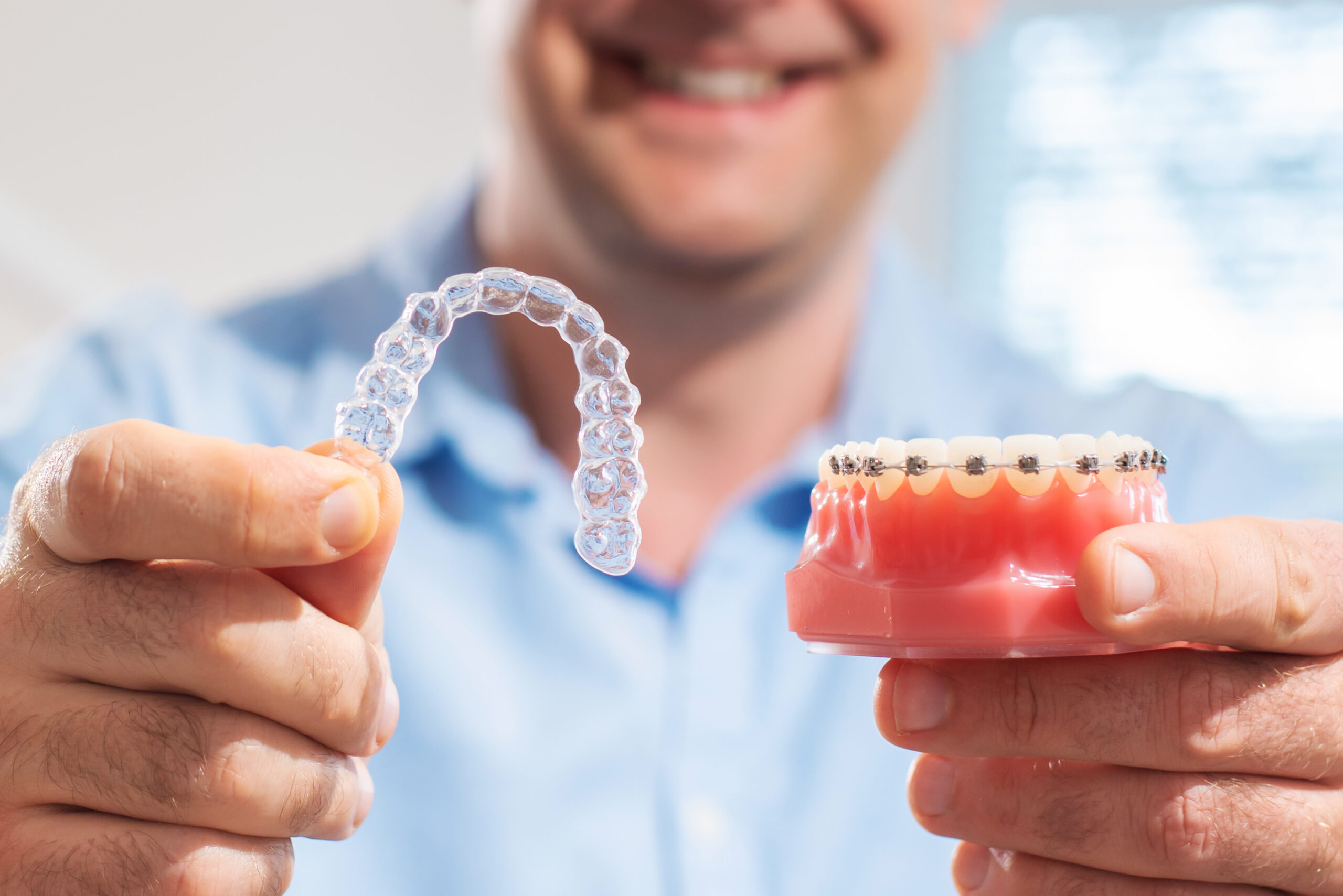 Smiling orthodontic patient learning about braces and Invisalign cost at Adirondack Orthodontics