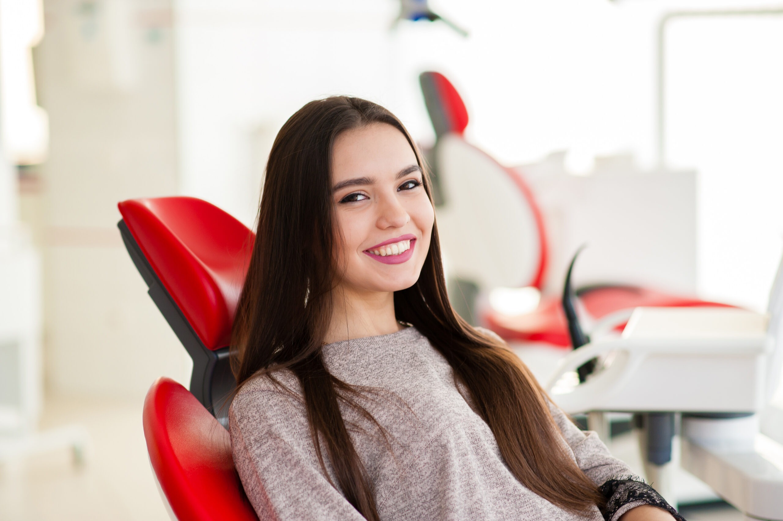 Patient protecting orthodontic results with custom retainers from Adirondack Orthodontics